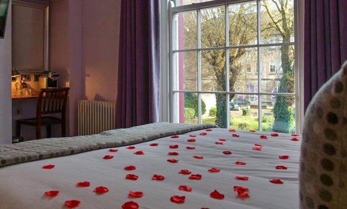 Rose petals on the bed make your holiday even more romantic! Pictured: rose petals on the bed in Illimani room, a classic room in the Morgans Townhous